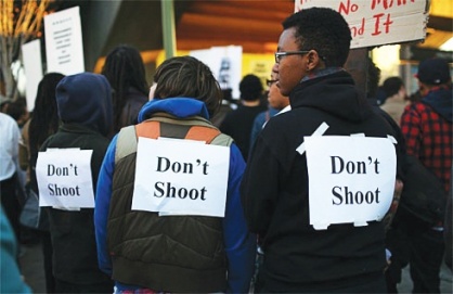 Three (pink) Protestors at Oscar Grant Rally have signs taped to their backs that say "Don't Shoot"